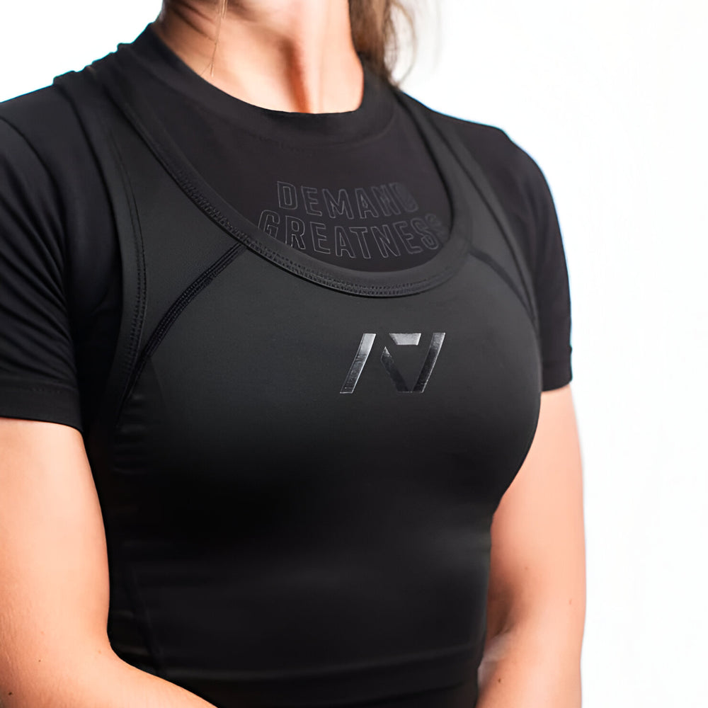 
                      
                        Singlet mujer para sentadilla, banca y peso muerto en negro
                      
                    